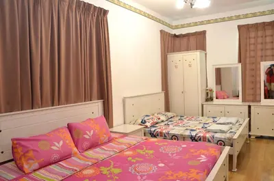 a bedroom with two beds and a couch at Near Gurney 3-Storey Event Hse by Felice Homestay in Tanjong Tokong