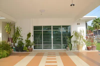 a house with a large window with plants at Near Gurney 3-Storey Event Hse by Felice Homestay in Tanjong Tokong