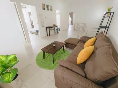 a living room with a brown couch and a table at Yarra Park, Up to 10 Pax, 5 Bedrooms, 4 Bathrooms, 2 Car Parks by Star Home in Sungai Petani