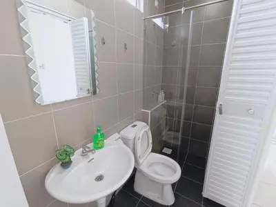 a bathroom with a white toilet and a sink at Yarra Park, Up to 10 Pax, 5 Bedrooms, 4 Bathrooms, 2 Car Parks by Star Home in Sungai Petani