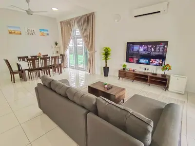 a living room with a couch and a dining room at Yarra Park, Up to 10 Pax, 5 Bedrooms, 4 Bathrooms, 2 Car Parks by Star Home in Sungai Petani
