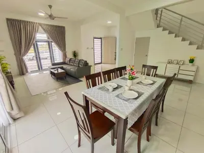 a dining room and living room with a table and chairs at Yarra Park, Up to 10 Pax, 5 Bedrooms, 4 Bathrooms, 2 Car Parks by Star Home in Sungai Petani