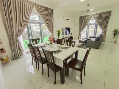 a dining room and living room with a table and chairs at Yarra Park, Up to 10 Pax, 5 Bedrooms, 4 Bathrooms, 2 Car Parks by Star Home in Sungai Petani