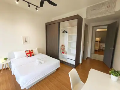 a bedroom with a white bed and a table at Rooftop Pool, Up to 8 Pax, 2 Bedrooms, 2 Bathrooms, 2 Car Parks by Star Home in George Town