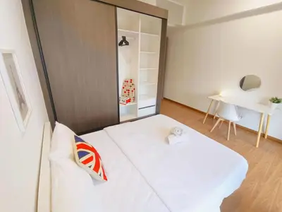 a bedroom with a white bed and a desk at Rooftop Pool, Up to 8 Pax, 2 Bedrooms, 2 Bathrooms, 2 Car Parks by Star Home in George Town