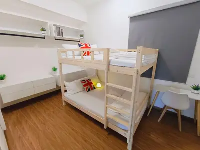 a bunk bed in a room with a ladder at Rooftop Pool, Up to 8 Pax, 2 Bedrooms, 2 Bathrooms, 2 Car Parks by Star Home in George Town