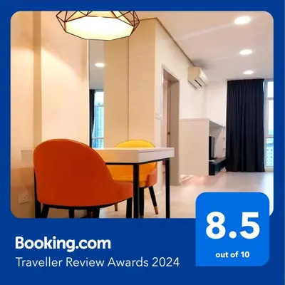 a dining room with a table and two orange chairs at Charming Studio 1BR 1LR Condo Georgetown \u9b45\u529b\u4e00\u5ba4\u4e00\u5385\u5957\u623f in George Town