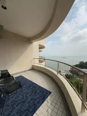 a balcony with a bench and a view of the ocean at 17 Jazz sweet beachfront resort in Tanjung Bungah