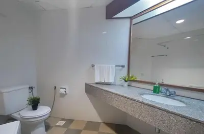 a bathroom with a toilet and a sink and a mirror at 17 Jazz sweet beachfront resort in Tanjung Bungah