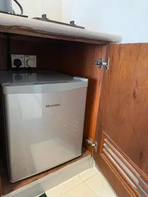 a water tank in a room with a wooden door at 17 Jazz sweet beachfront resort in Tanjung Bungah