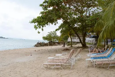 a group of chairs and tables on a beach at 17 Jazz sweet beachfront resort in Tanjung Bungah