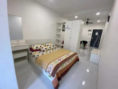 a bedroom with a bed in a white room at Jom singgah in Seri Iskandar