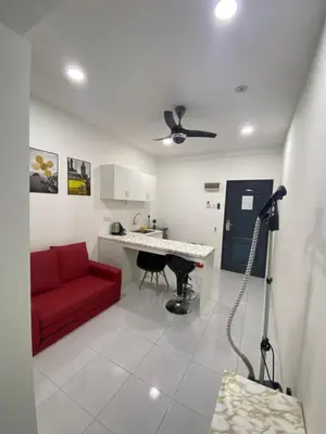 a living room with a red couch and a table at Jom singgah in Seri Iskandar