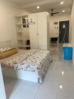 a bedroom with a bed and white cabinets at Jom singgah in Seri Iskandar