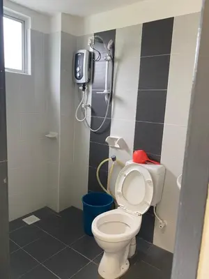 a bathroom with a toilet and a shower at Jom singgah in Seri Iskandar