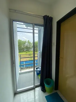 a sliding glass door leading to a balcony with a view at Jom singgah in Seri Iskandar