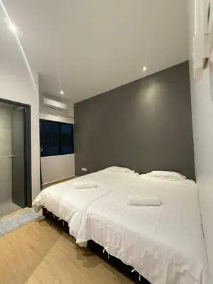 a bedroom with a large bed with two towels on it at Villa 8812 \u6781\u7b80\u98ce\u6c11\u5bbf \u8212\u9002\u73b0\u4ee3\u98ce in Kampong Sungai Udang