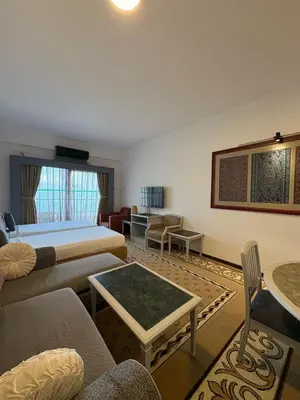 a hotel room with a bed and a living room at Seaview Deluxe Rainbow Paradise Tg Bungah 6pax in Tanjung Bungah