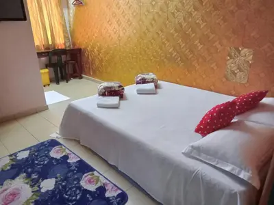 a bed with polka dot pillows on top of it at Hotel Muallim Tanjung Malim in Tanjung Malim
