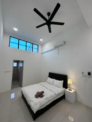 a bedroom with a bed with a ceiling fan at Ipoh Sunway Tambun Spacious Homestay in Ipoh