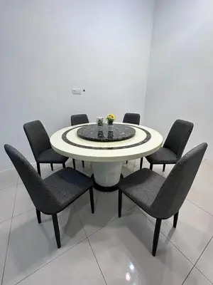 a white table with chairs and a table with flowers on it at Ipoh Sunway Tambun Spacious Homestay in Ipoh