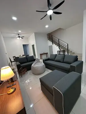 a living room with two couches and a ceiling fan at Ipoh Sunway Tambun Spacious Homestay in Ipoh