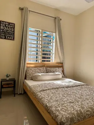 a bed in a room with a window and a bed sidx sidx sidx at DeAsmarra Homestay in Tanjung Piandang