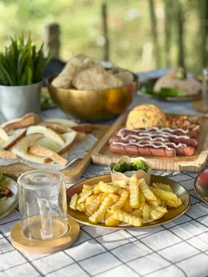 a table topped with different types of food on plates at DeAsmarra Homestay in Tanjung Piandang