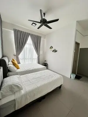 a bedroom with two beds and a ceiling fan at Aloft Cameron Highlands B in Brinchang