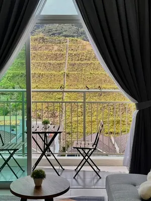 a room with a large window with a table and chairs at Aloft Cameron Highlands B in Brinchang