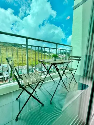 a table and chairs on a balcony with a view at Aloft Cameron Highlands B in Brinchang