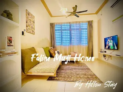 a living room with a couch and a window at Muji Home Falim in Ipoh
