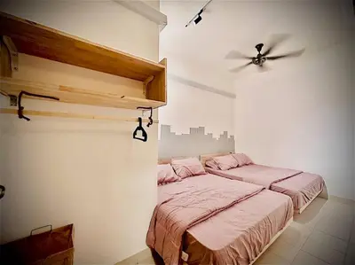 a bedroom with two beds and a ceiling fan at Muji Home Falim in Ipoh