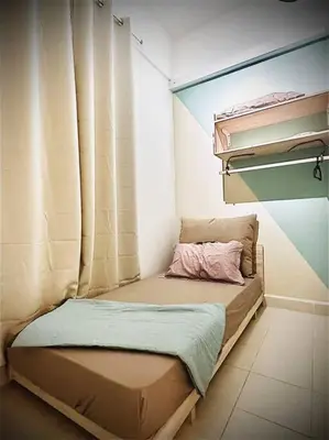 a small bed in a room with a window at Muji Home Falim in Ipoh