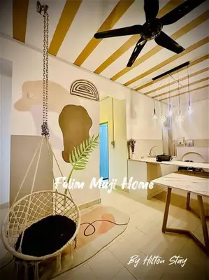 a hanging chair in a room with a kitchen at Muji Home Falim in Ipoh