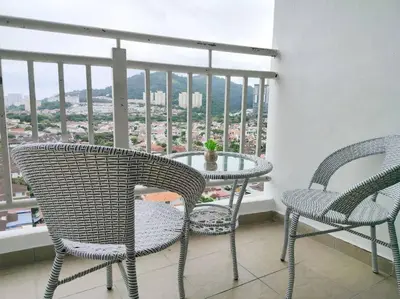 two chairs and a table on a balcony with a view at Comfy Home Near to SPICE and USM in Bayan Lepas