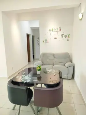 a living room with a table and a couch at Comfy Home Near to SPICE and USM in Bayan Lepas