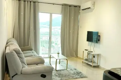 a living room with a couch and a chair and a television at Comfy Home Near to SPICE and USM in Bayan Lepas