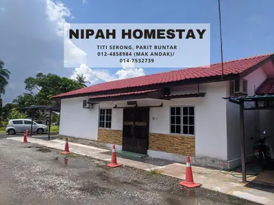 a building with orange cones in front of it at Nipah Homestay Parit Buntar in Parit Buntar