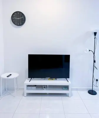 a flat screen tv sitting on a white entertainment center at TheSun #Studio #BayanLepas #Pisa in Kampong Manggis
