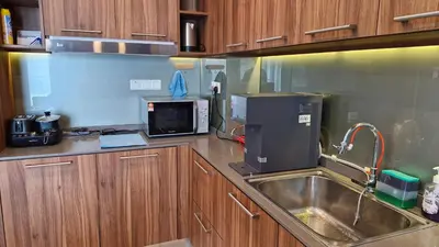 a kitchen with a sink and a microwave at H&W Sunway Onsen Suites Services Tambun Ipoh S-07-05 in Ipoh