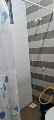 a shower with a hose in a bathroom at D'HutHomestay Puncak Iskandar in Seri Iskandar