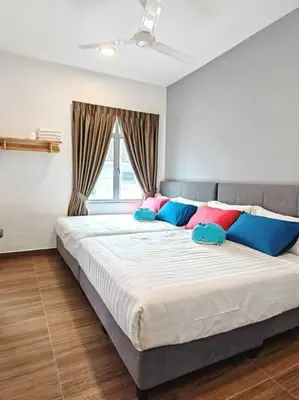 a bedroom with a large bed with colorful pillows at W45WarmStay@GoldenHillsNightMarket in Brinchang