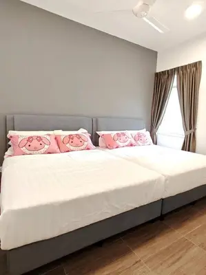 a bedroom with a large bed with pink pillows at W45WarmStay@GoldenHillsNightMarket in Brinchang