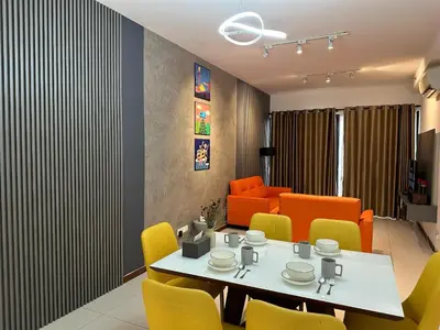 a dining room with a table and chairs at NEW 4Queen Bed 3 Room 2CP near Gurney with tvbox and KTV Set in Tanjong Tokong
