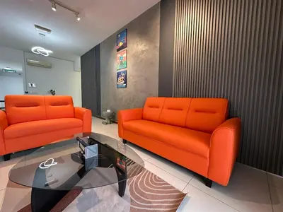 a lobby with two orange chairs and a glass table at NEW 4Queen Bed 3 Room 2CP near Gurney with tvbox and KTV Set in Tanjong Tokong