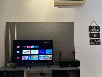 a flat screen tv sitting on top of a table at NEW 4Queen Bed 3 Room 2CP near Gurney with tvbox and KTV Set in Tanjong Tokong