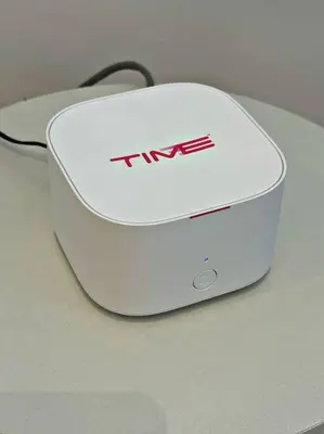 a white router sitting on top of a table at NEW 4Queen Bed 3 Room 2CP near Gurney with tvbox and KTV Set in Tanjong Tokong