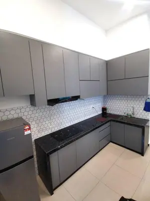 a kitchen with white cabinets and black counter tops at Paradise Home- 10Pax/4CarPark- Pg Bridge/KPJ Hosp in Bukit Mertajam