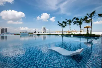 a swimming pool with a white couch in the water at Paradise Home- 10Pax/4CarPark- Pg Bridge/KPJ Hosp in Bukit Mertajam